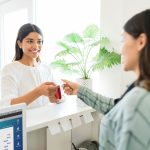 Client Paying For Beauty Treatment To Receptionist In Spa