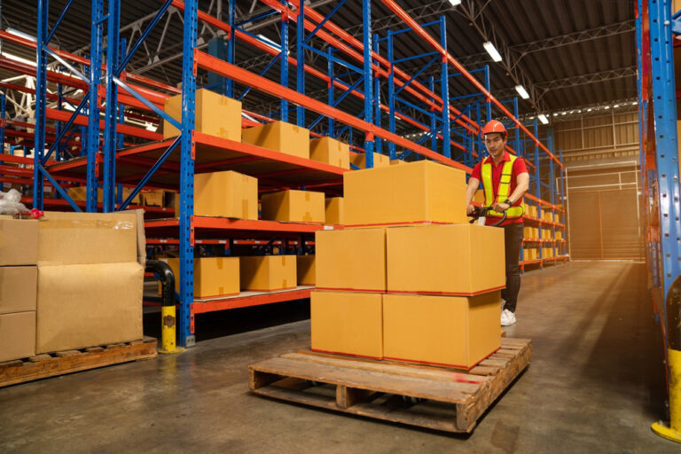 Male,Warehouse,Workers,Pulling,A,Pallet,Truck,,Boxes,Are,On